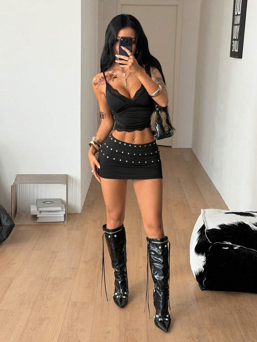 Women's black ultra low waist mini pencil skirt with rhinestone studded detail, skinny fit, and stretchy polyester fabric.
