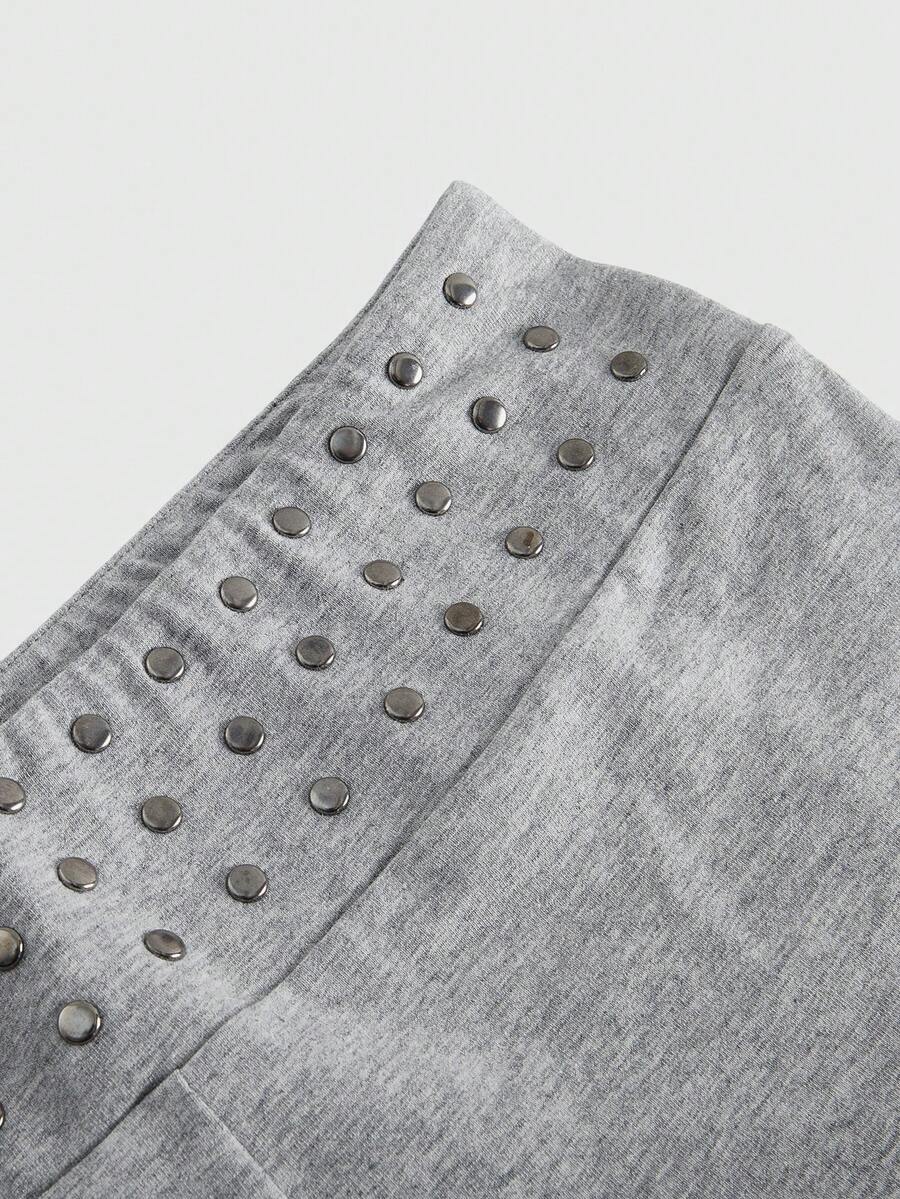 Women's grey Y2K two-piece set featuring an off-the-shoulder crop top with studded details and matching mini shorts.