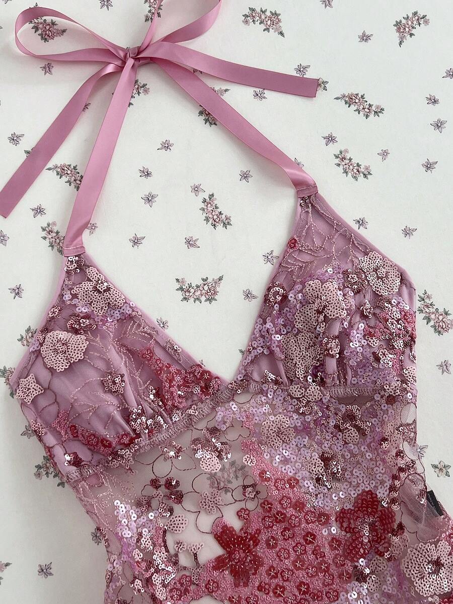 Pink sheer lace tie-up halter crop top featuring floral sequin patchwork, deep V-neck, and backless tie-back design.