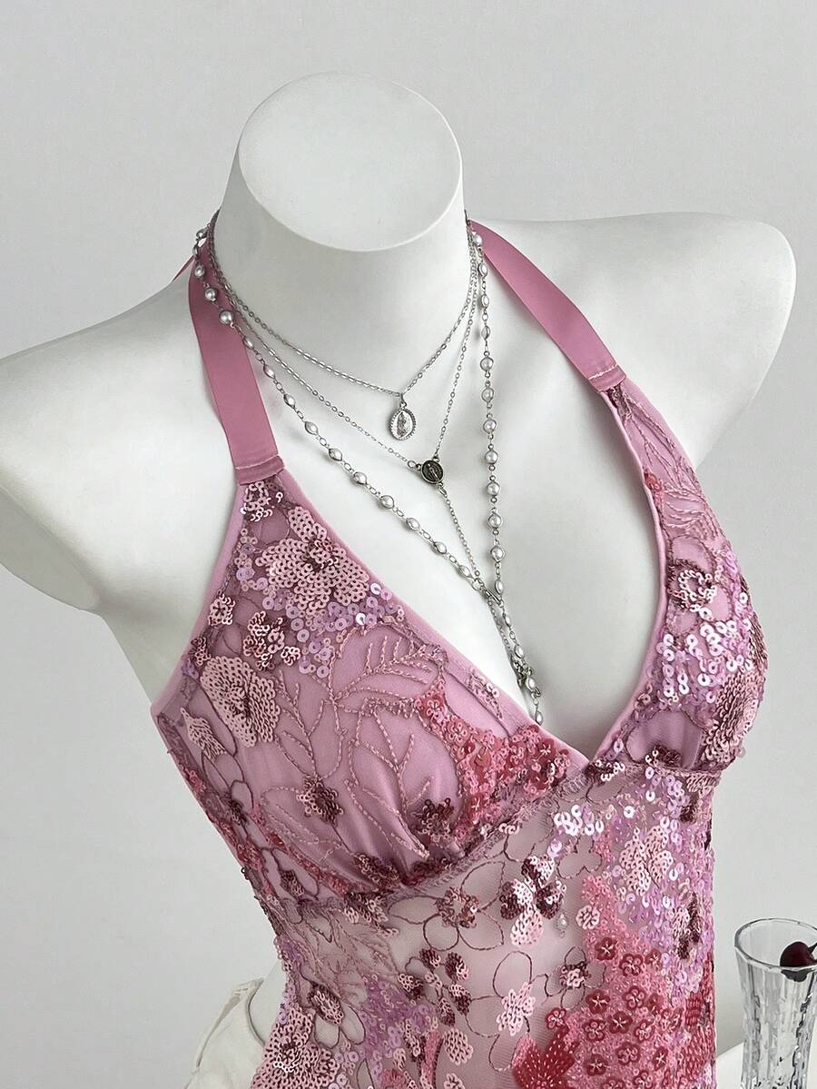 Pink sheer lace tie-up halter crop top featuring floral sequin patchwork, deep V-neck, and backless tie-back design.