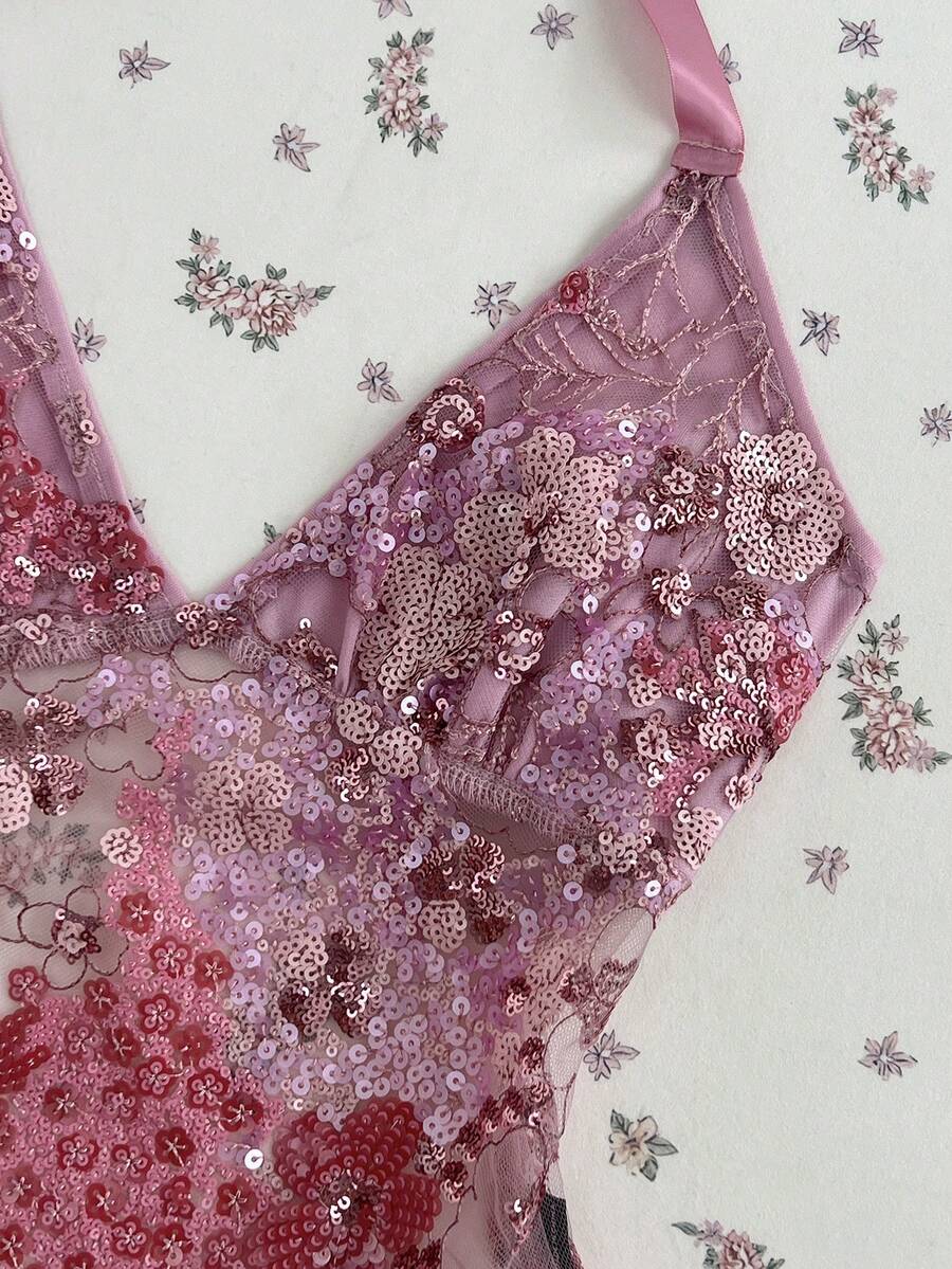 Pink sheer lace tie-up halter crop top featuring floral sequin patchwork, deep V-neck, and backless tie-back design.