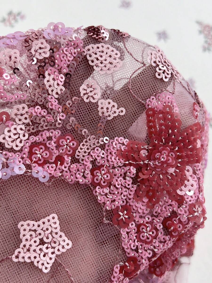 Pink sheer lace tie-up halter crop top featuring floral sequin patchwork, deep V-neck, and backless tie-back design.