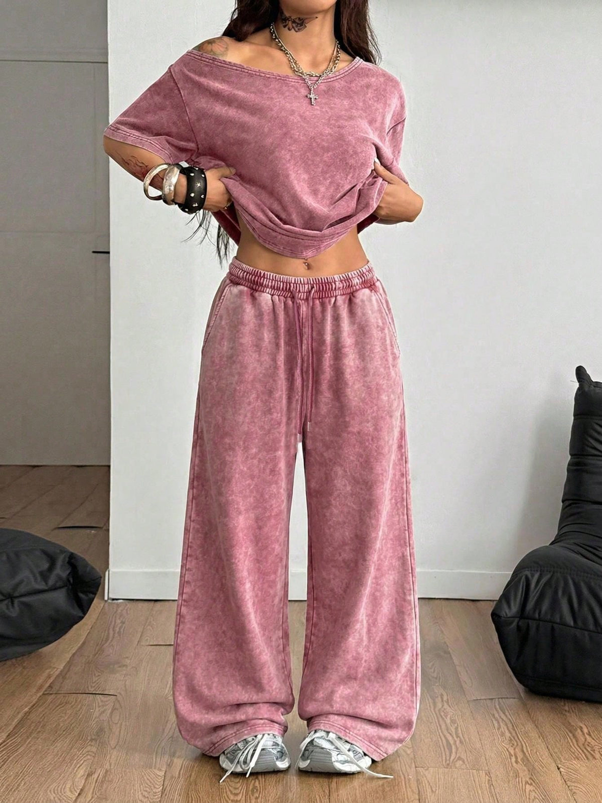 Women's two-piece outfit featuring an oversized asymmetrical neck t-shirt and matching wide-leg drawstring sweatpants.