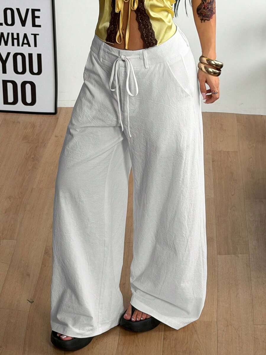 Women's casual straight leg striped woven pants featuring a low waist and zipper fly closure.