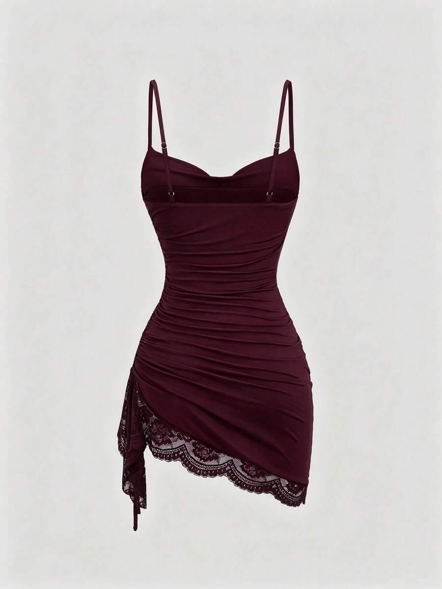 Women's short cami dress with cowl neck, spaghetti straps, contrast lace patchwork, pleated detail, and asymmetrical hem