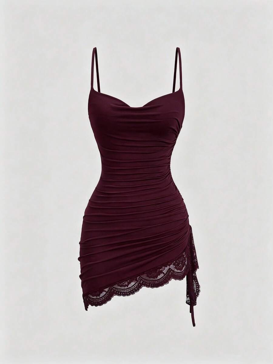 Women's short cami dress with cowl neck, spaghetti straps, contrast lace patchwork, pleated detail, and asymmetrical hem
