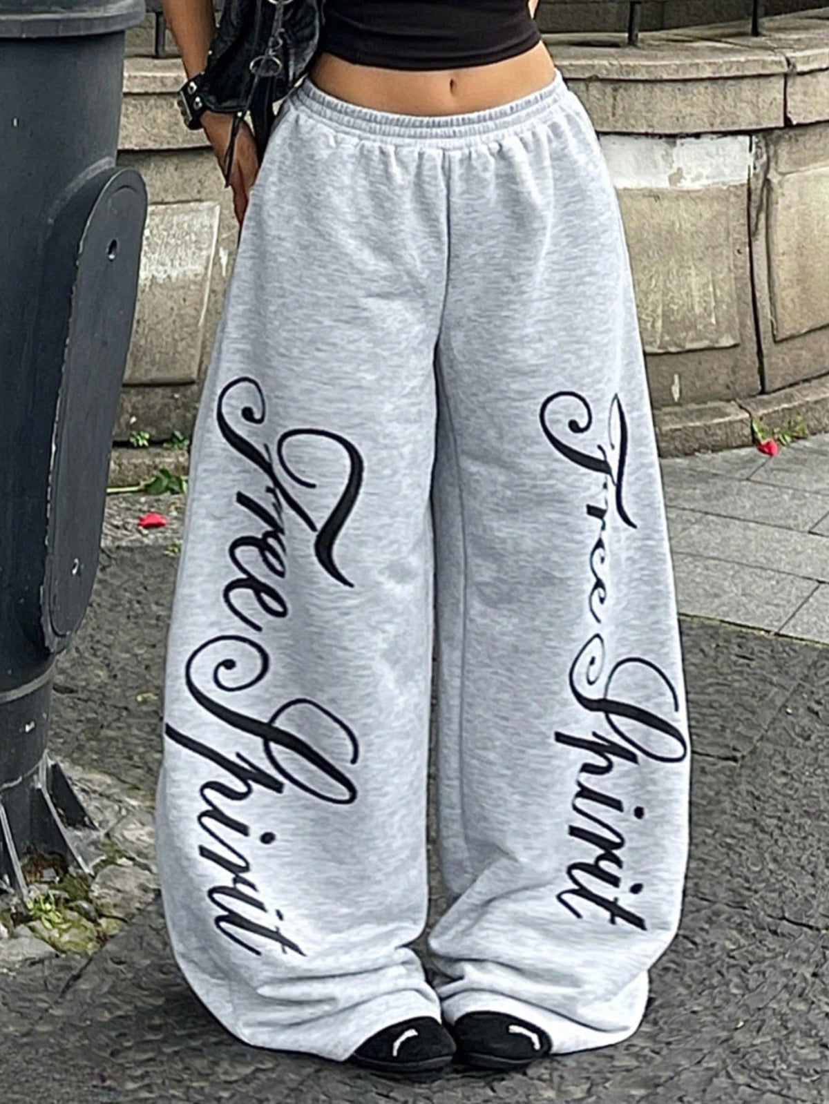 Women's loose fit wide leg graphic sweatpants in light grey with an elastic drawstring waistband