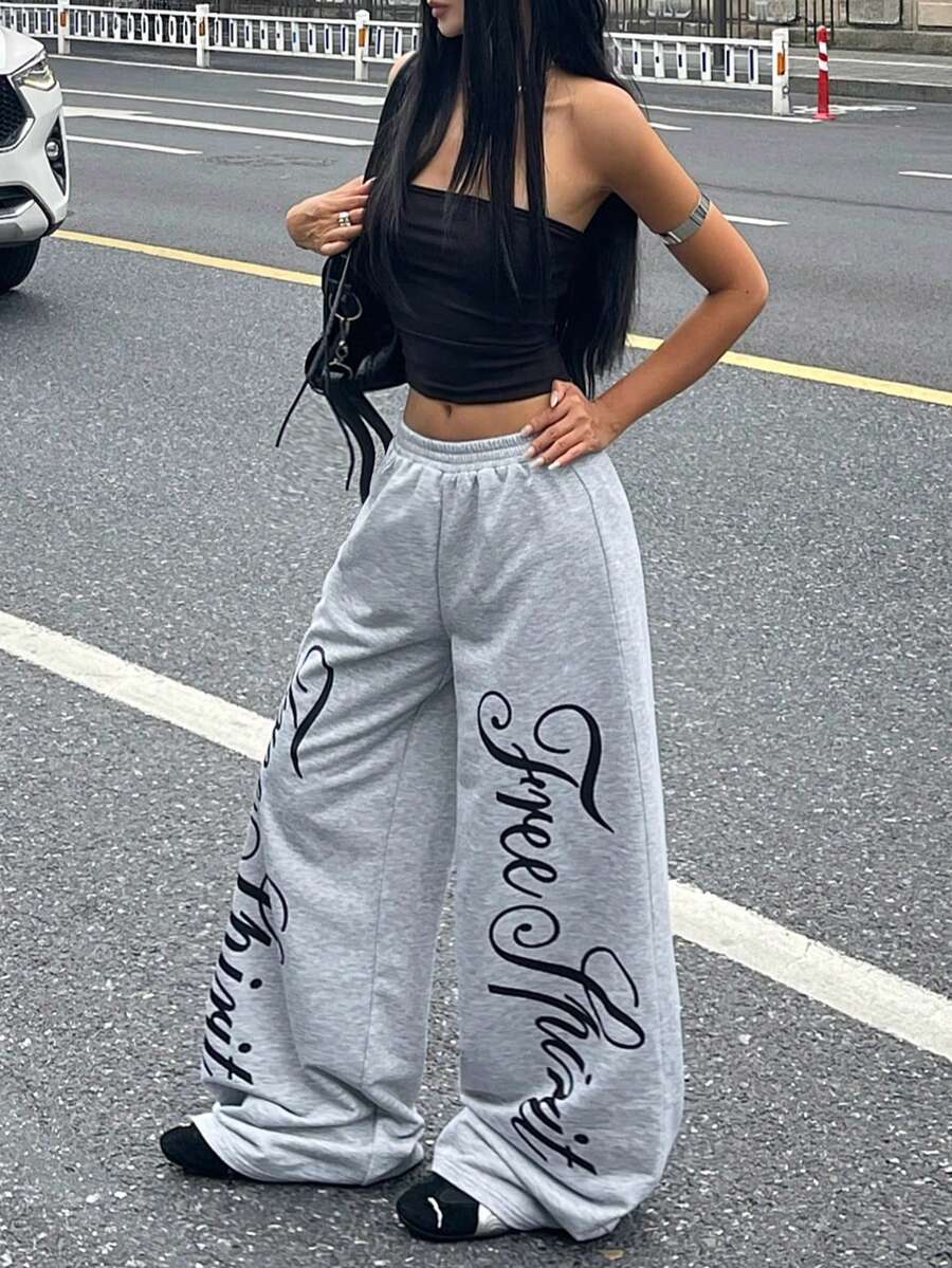 Women's loose fit wide leg graphic sweatpants in light grey with an elastic drawstring waistband