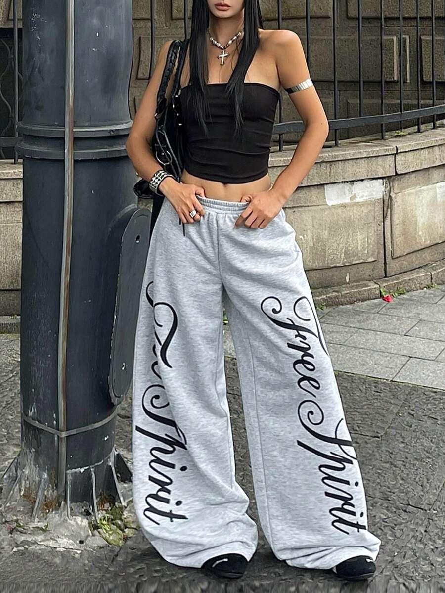 Women's loose fit wide leg graphic sweatpants in light grey with an elastic drawstring waistband
