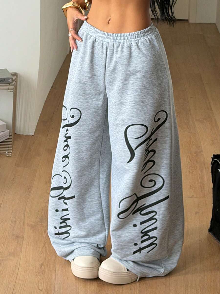 Women's loose fit wide leg graphic sweatpants in light grey with an elastic drawstring waistband