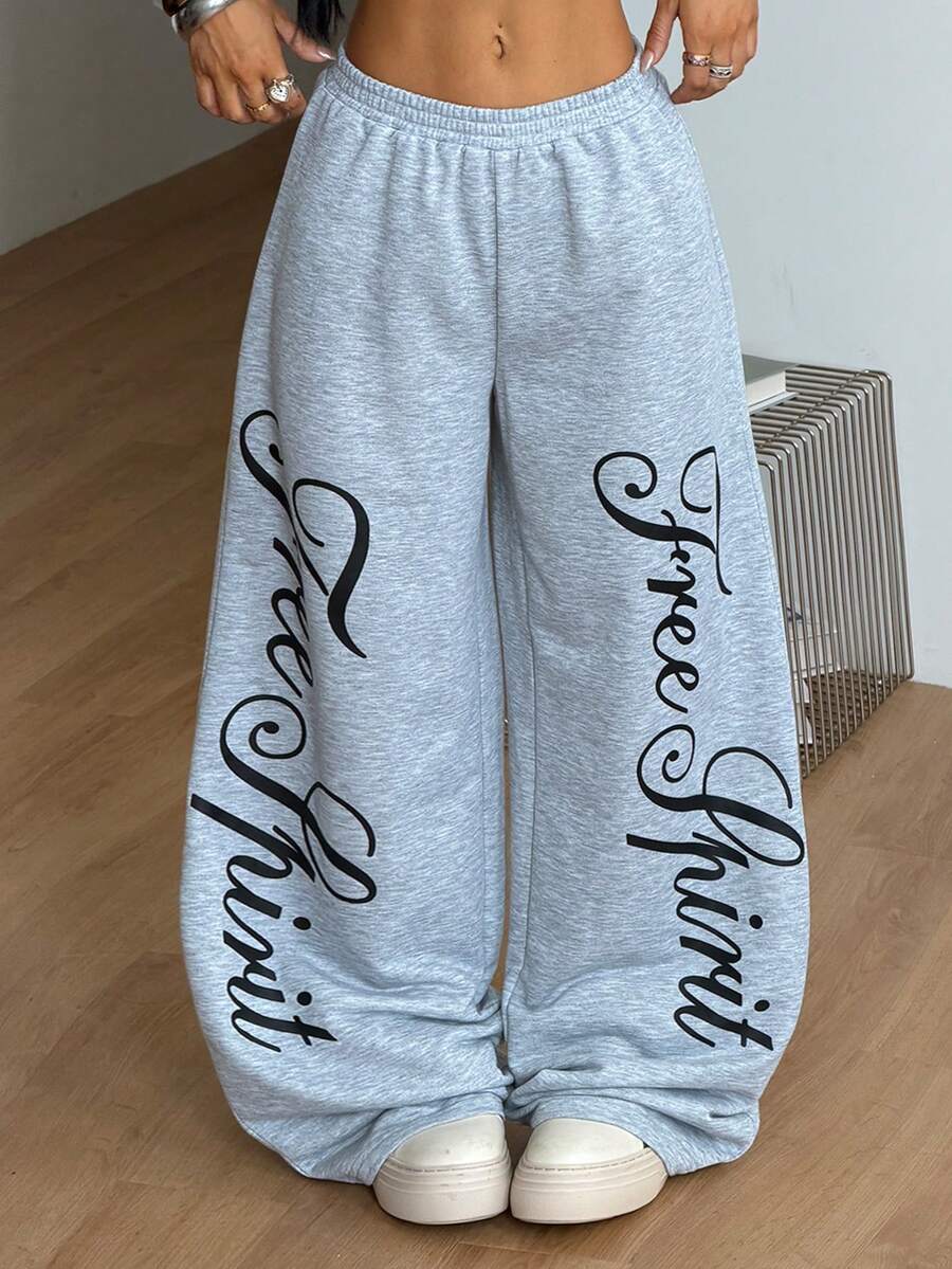 Women's loose fit wide leg graphic sweatpants in light grey with an elastic drawstring waistband
