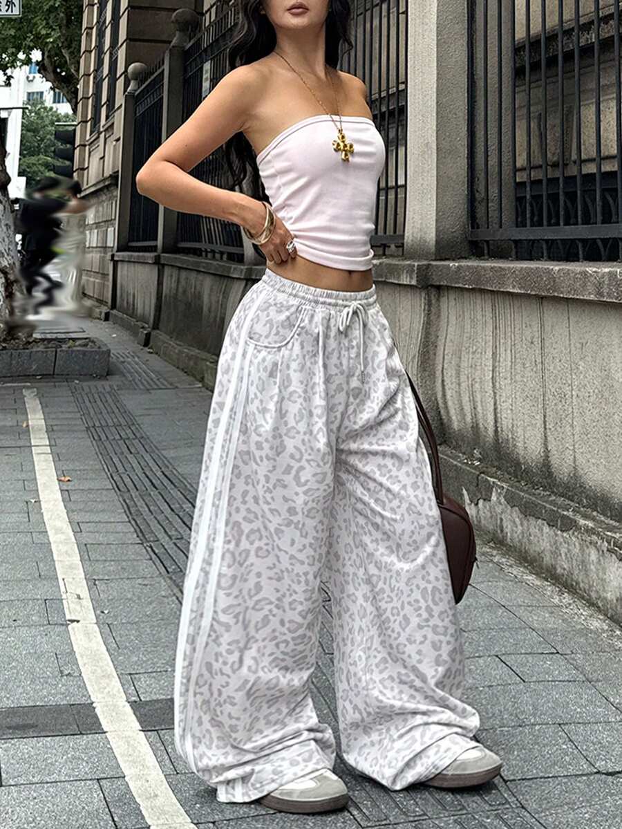 Women's casual straight leg baggy lounge pants in light grey with an adjustable drawstring waist and side pockets.
