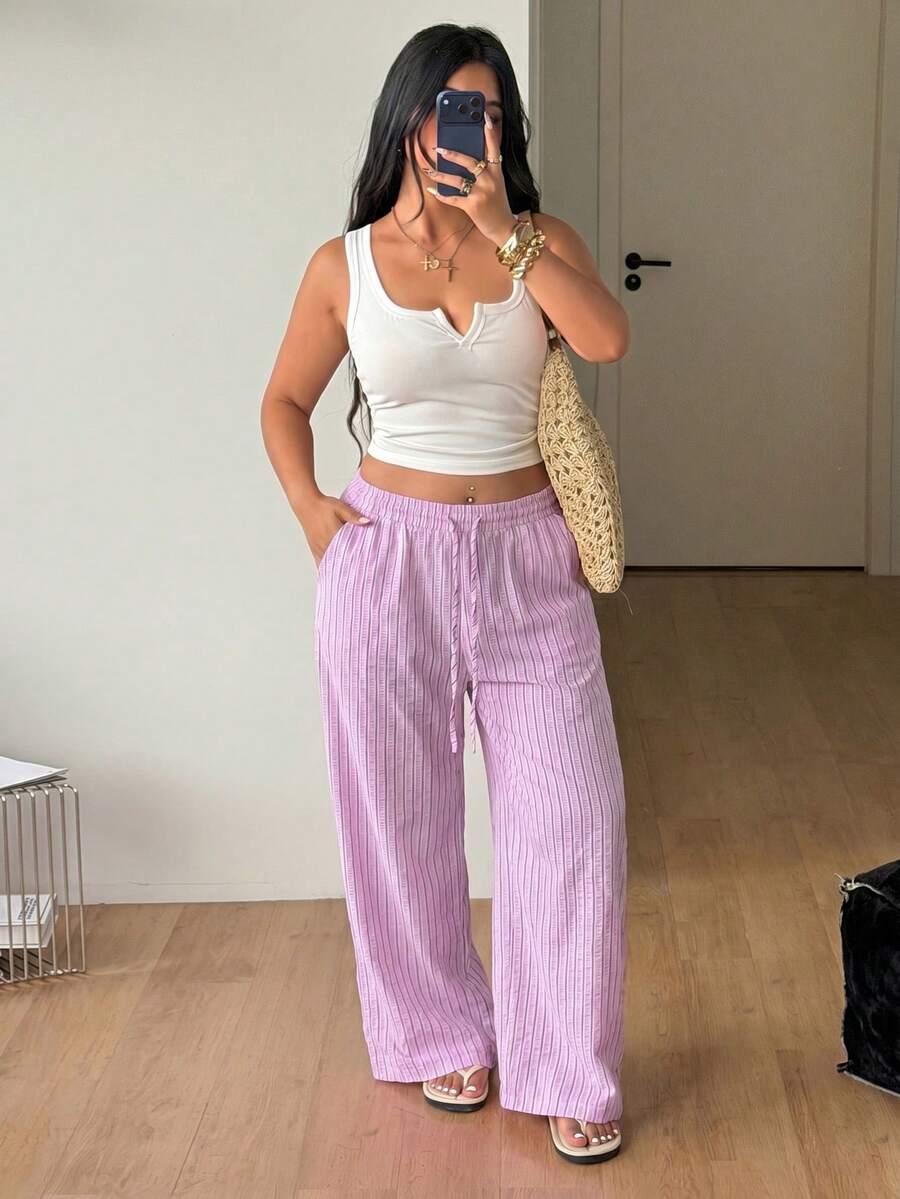 Plus size women's striped loose straight leg cropped pants with pleated detailing and side pockets