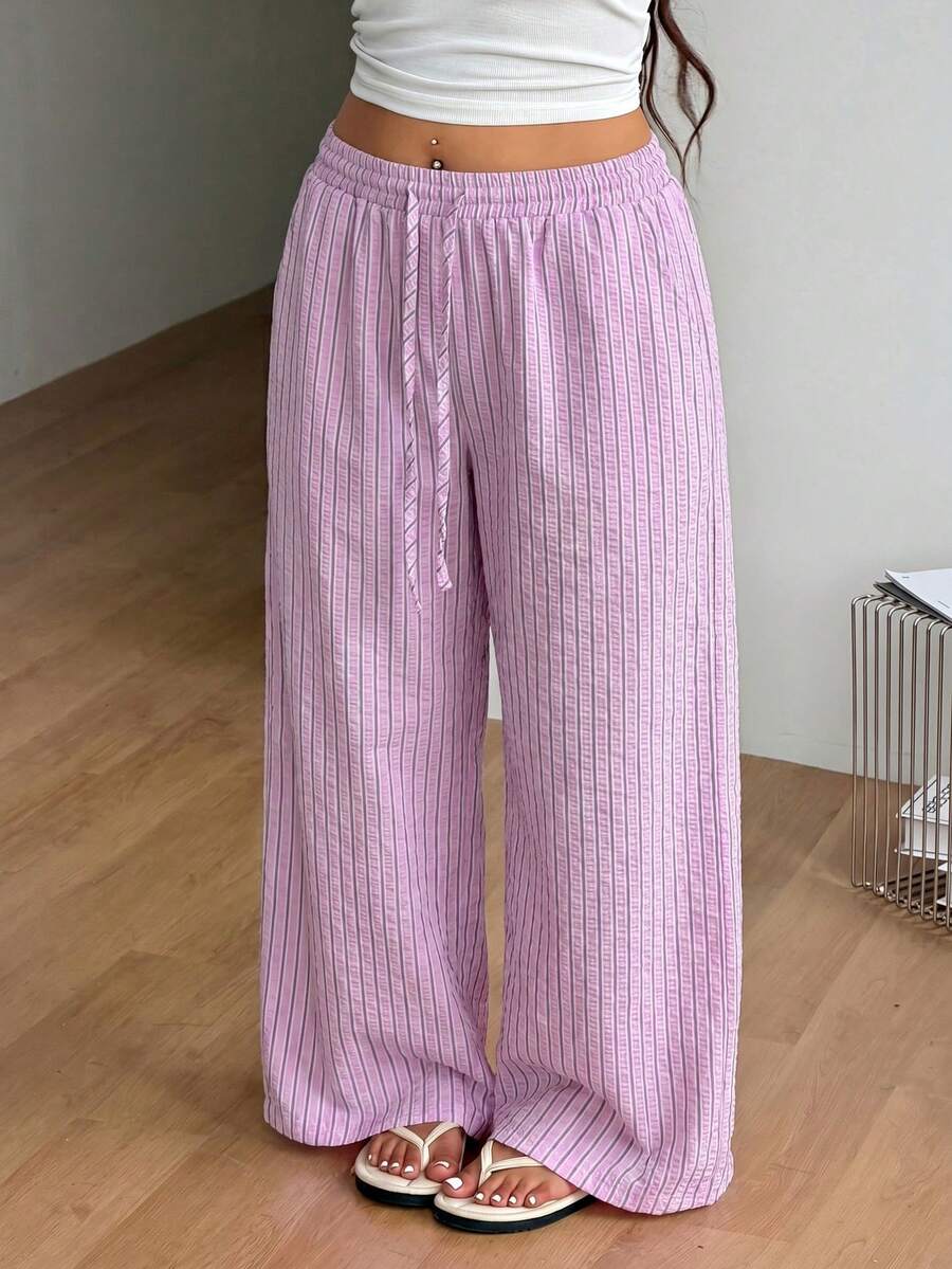 Plus size women's striped loose straight leg cropped pants with pleated detailing and side pockets