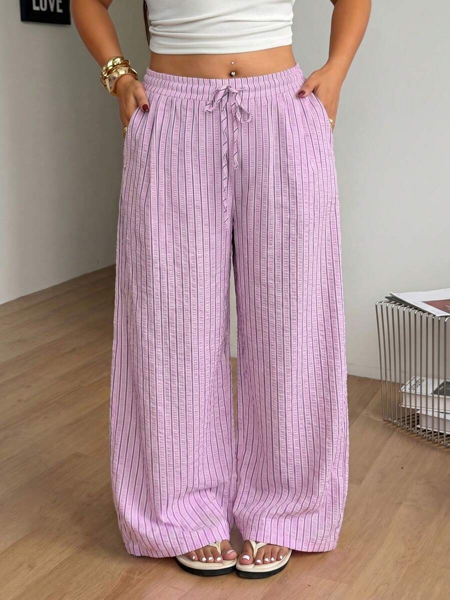 Plus size women's striped loose straight leg cropped pants with pleated detailing and side pockets