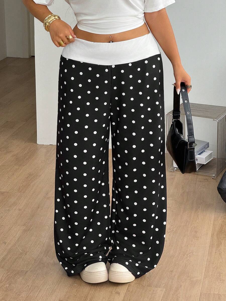 Women's casual straight leg sweatpants featuring a black and white polka dot design with an elastic waistband.