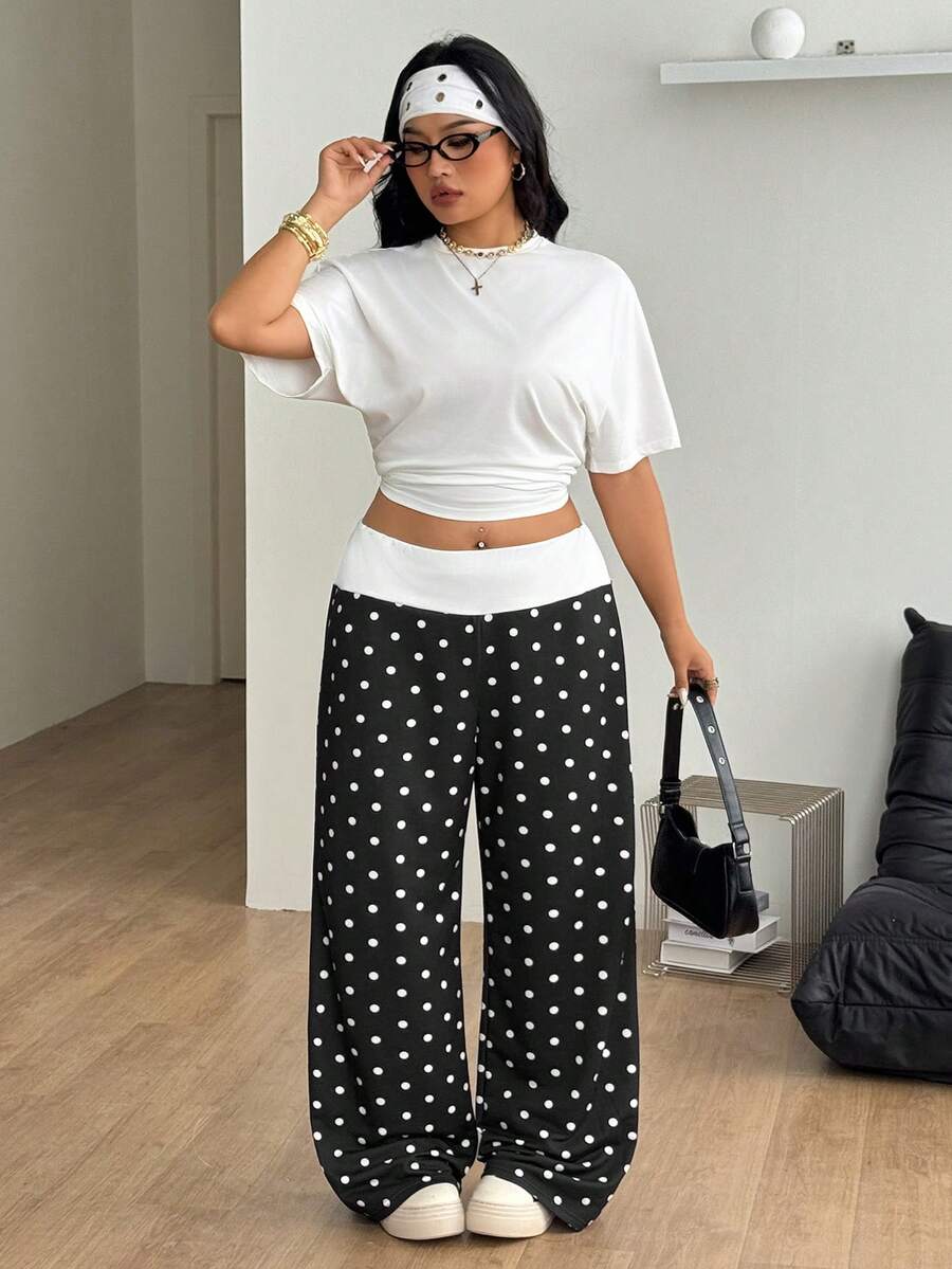 Women's casual straight leg sweatpants featuring a black and white polka dot design with an elastic waistband.