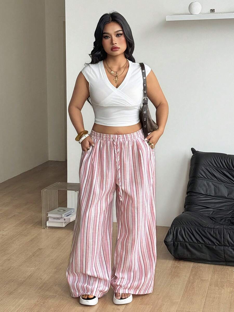 Women's loose straight leg cotton pants featuring a high waist with an adjustable drawstring knot and functional side pockets.