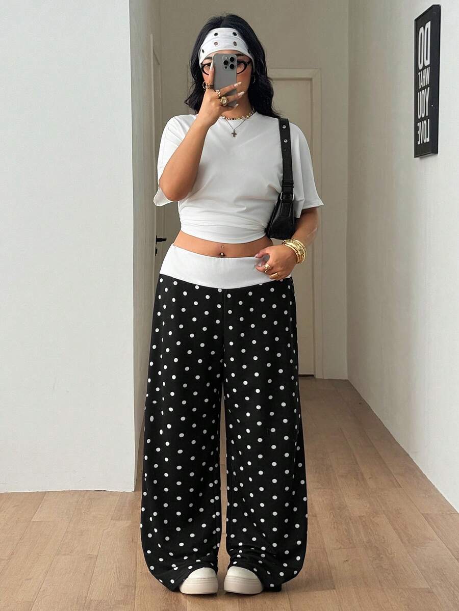 Women's casual straight leg sweatpants featuring a black and white polka dot design with an elastic waistband.