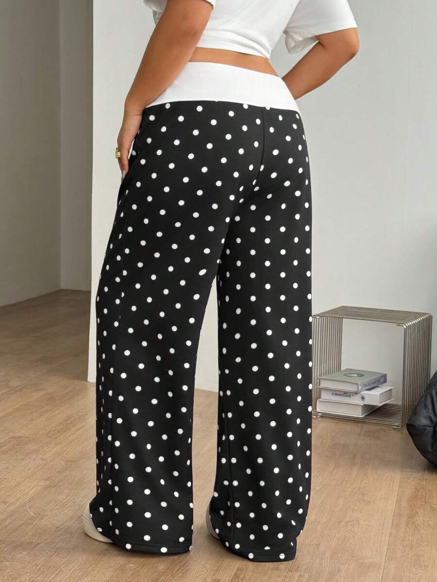 Women's casual straight leg sweatpants featuring a black and white polka dot design with an elastic waistband.
