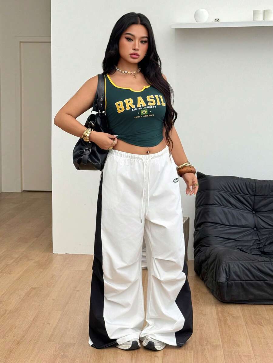 Women's high waist wide leg pants in black featuring leopard print patchwork details and an elastic drawstring waistband.