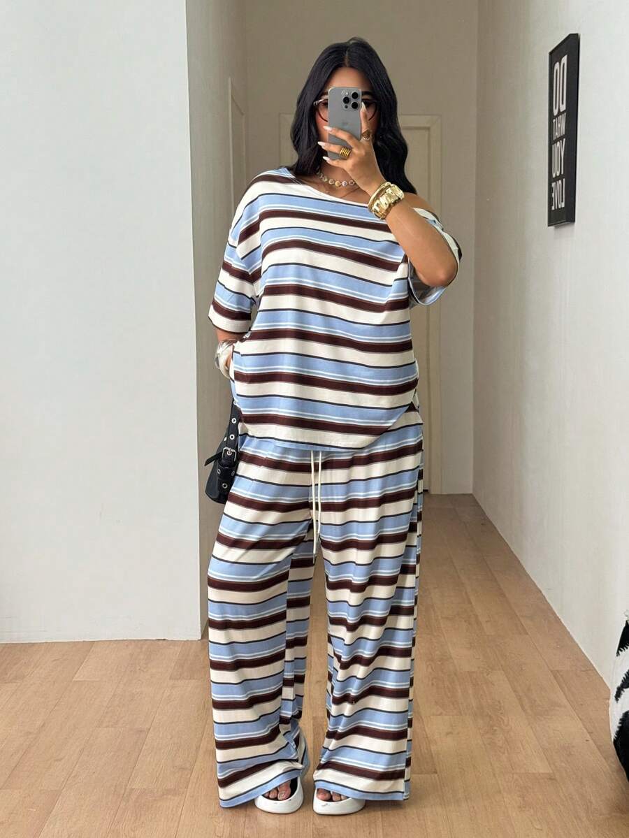 Striped two-piece casual outfit featuring an asymmetrical off-shoulder short-sleeve top and matching loose wide-leg pants with side pockets.
