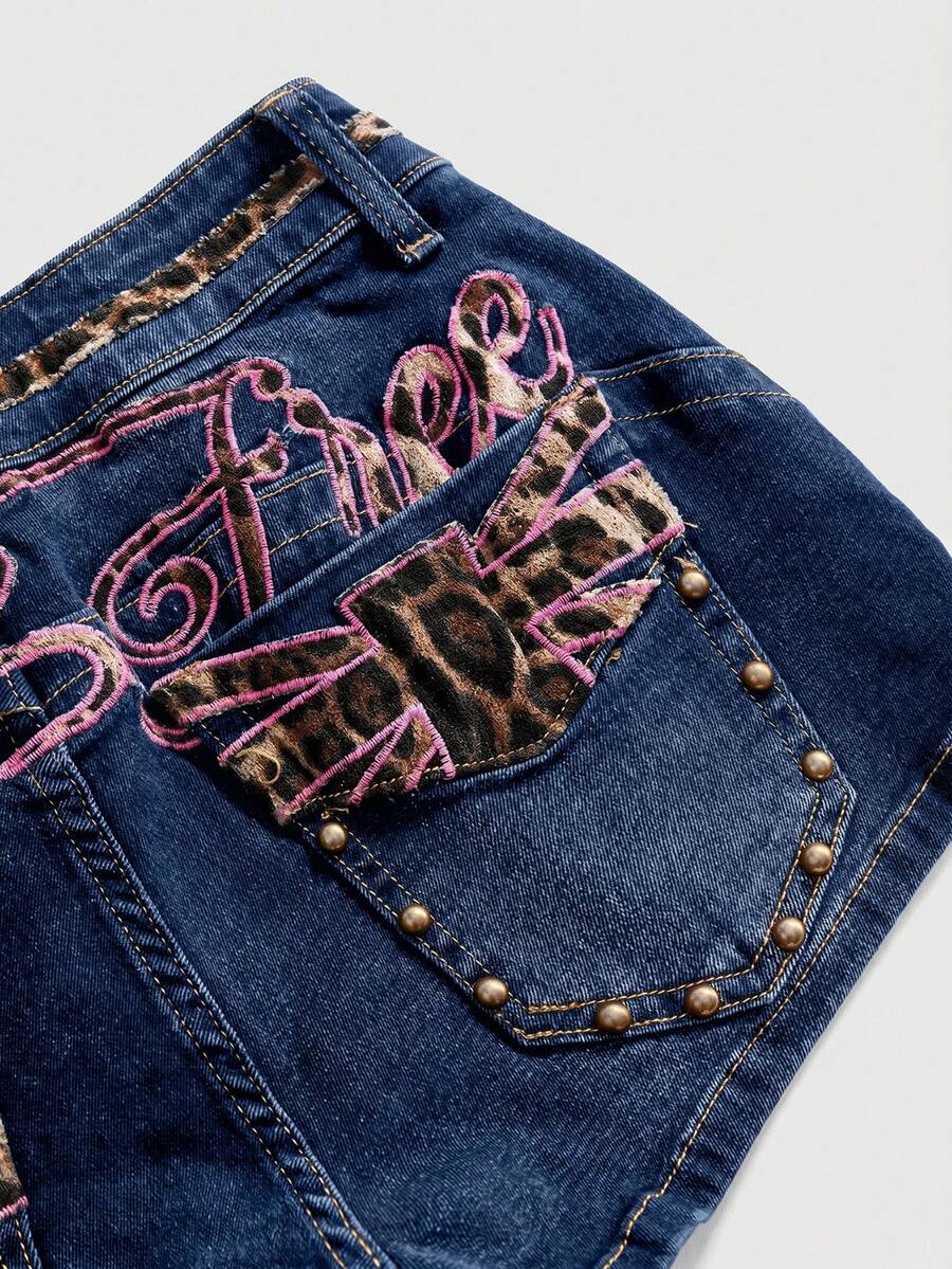 Women's super low waist shorts with leopard print embroidery, button and zipper closure, and raw hem detailing.
