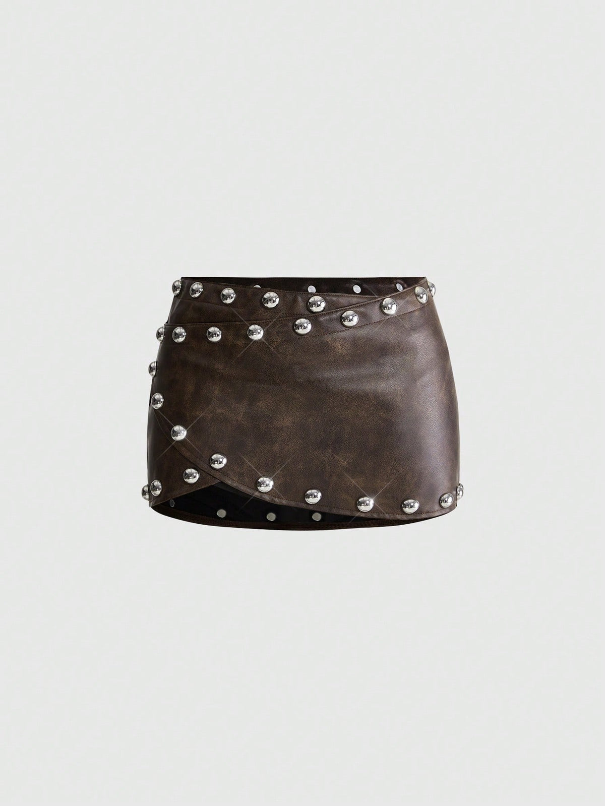 Women's bodycon mini skirt featuring an ultra low layered waistline with studded rivet details in a solid color finish.