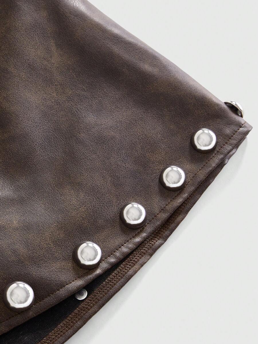 Women's bodycon mini skirt featuring an ultra low layered waistline with studded rivet details in a solid color finish.