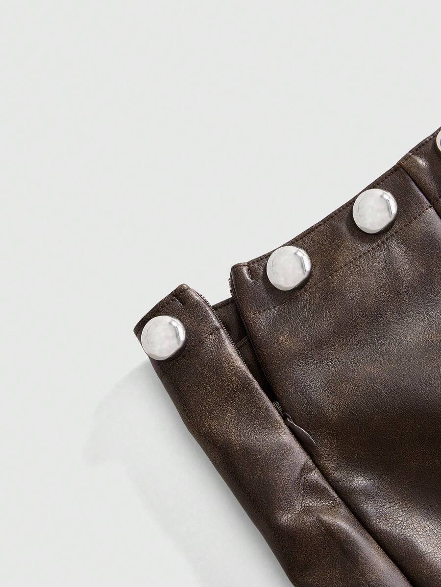 Women's bodycon mini skirt featuring an ultra low layered waistline with studded rivet details in a solid color finish.