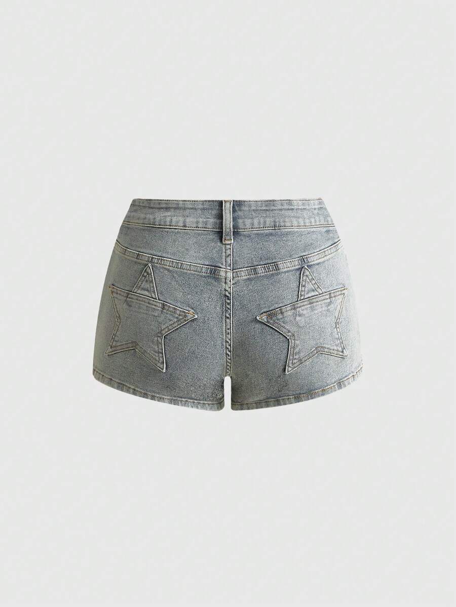 Women's ultra low waist mini shorts with back pockets, zipper fly, button detail, random print, and star patch in a grunge punk Y2K style.