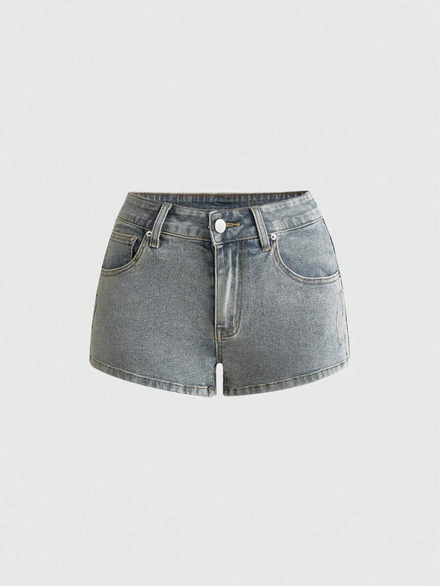 Women's ultra low waist mini shorts with back pockets, zipper fly, button detail, random print, and star patch in a grunge punk Y2K style.