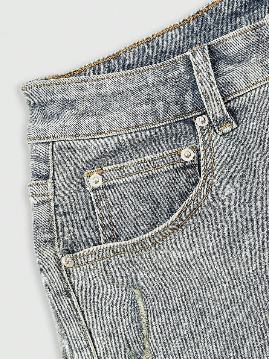 Women's ultra low waist mini shorts with back pockets, zipper fly, button detail, random print, and star patch in a grunge punk Y2K style.