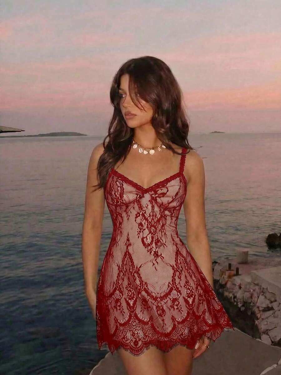 Women's short lace cami dress with spaghetti straps, contrast lace detailing, high waist, slim fit, and straight hem.