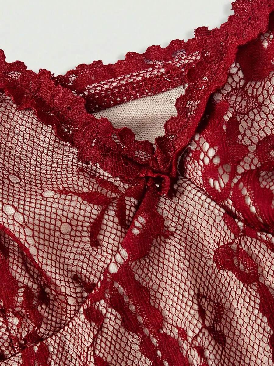 Women's short lace cami dress with spaghetti straps, contrast lace detailing, high waist, slim fit, and straight hem.