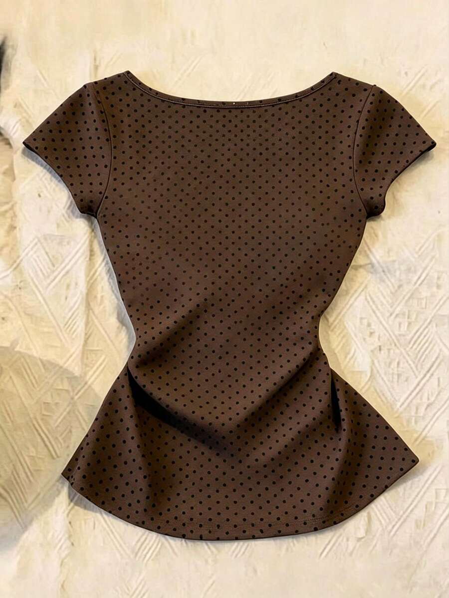 Women's polka dot short sleeve raglan t-shirt with a twist front detail and contrast collar.