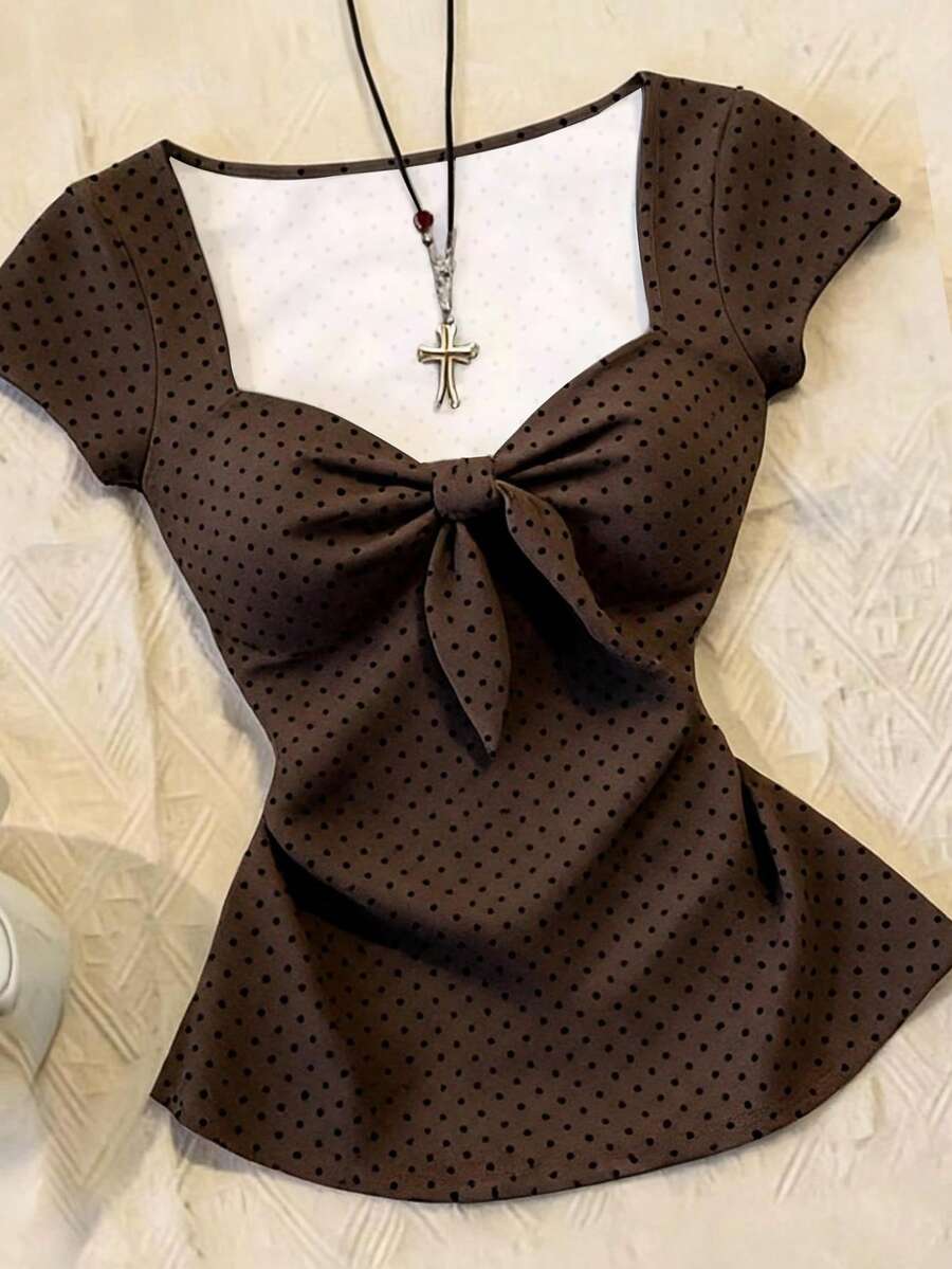 Women's polka dot short sleeve raglan t-shirt with a twist front detail and contrast collar.