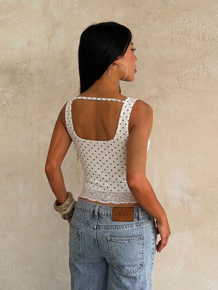 Women's white sleeveless crop tank top with contrast lace details, strap neckline, and graphic plant pattern in a slim fit.