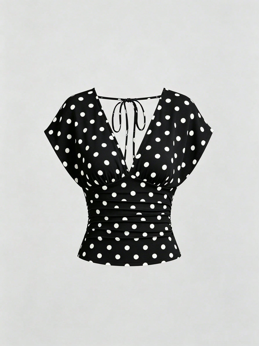 Women's black knitted t-shirt featuring a reversible deep v-neckline, batwing cap sleeves, ruched detailing, and a slim fit waist.