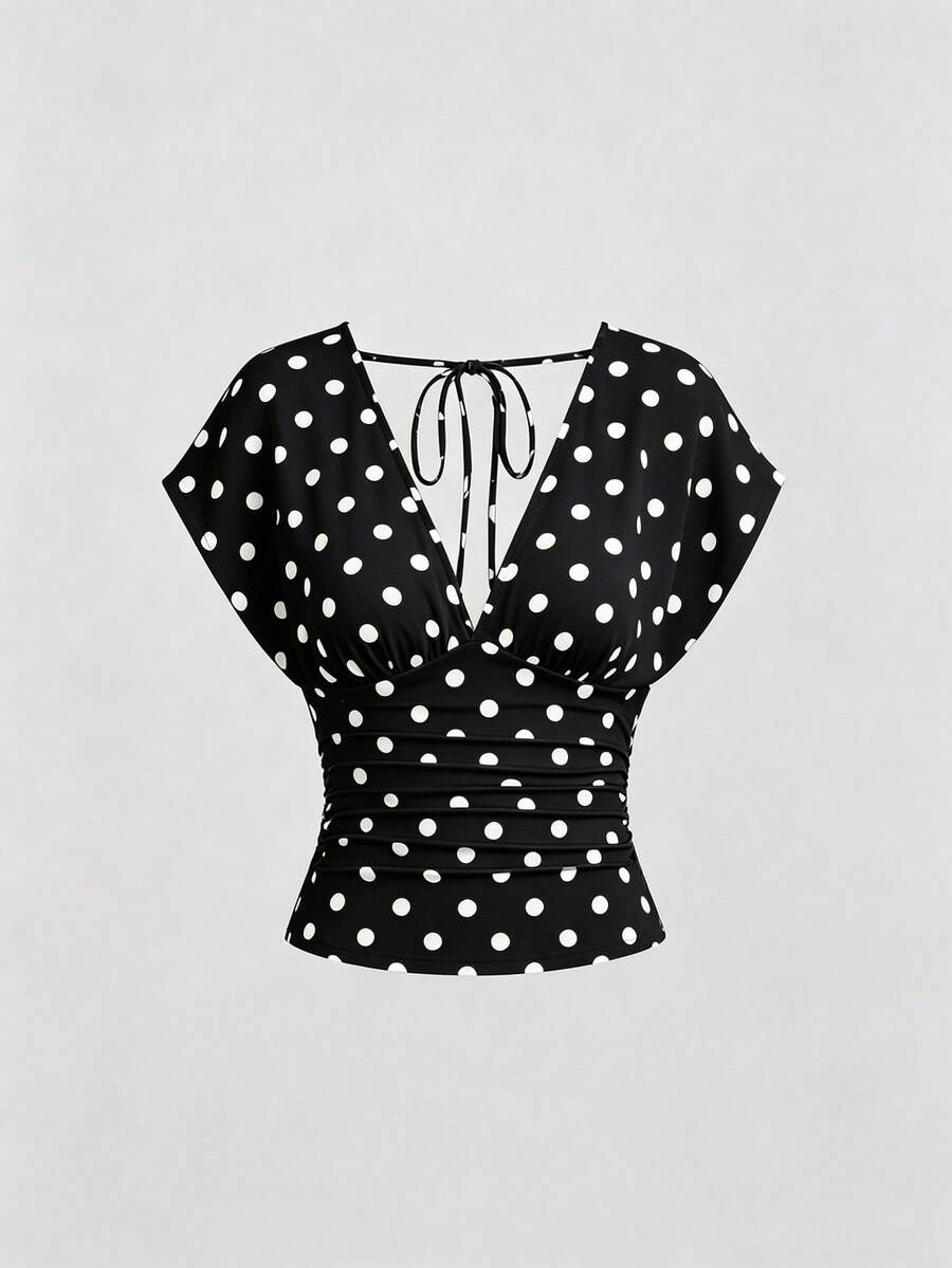 Women's black knitted t-shirt featuring a reversible deep v-neckline, batwing cap sleeves, ruched detailing, and a slim fit waist.