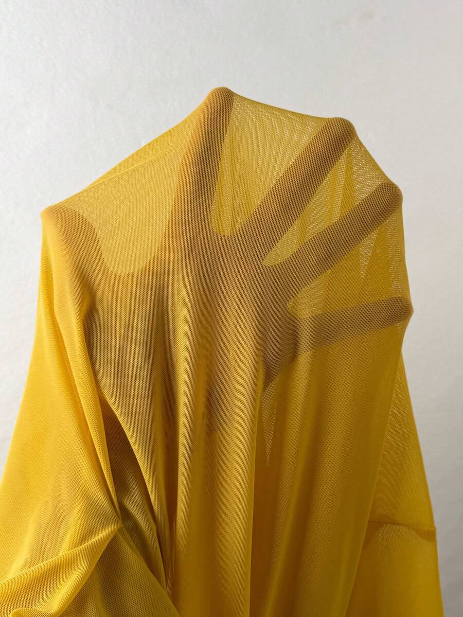 Light yellow asymmetrical ruffle long skirt with a low-rise waist and stretch knit fabric.