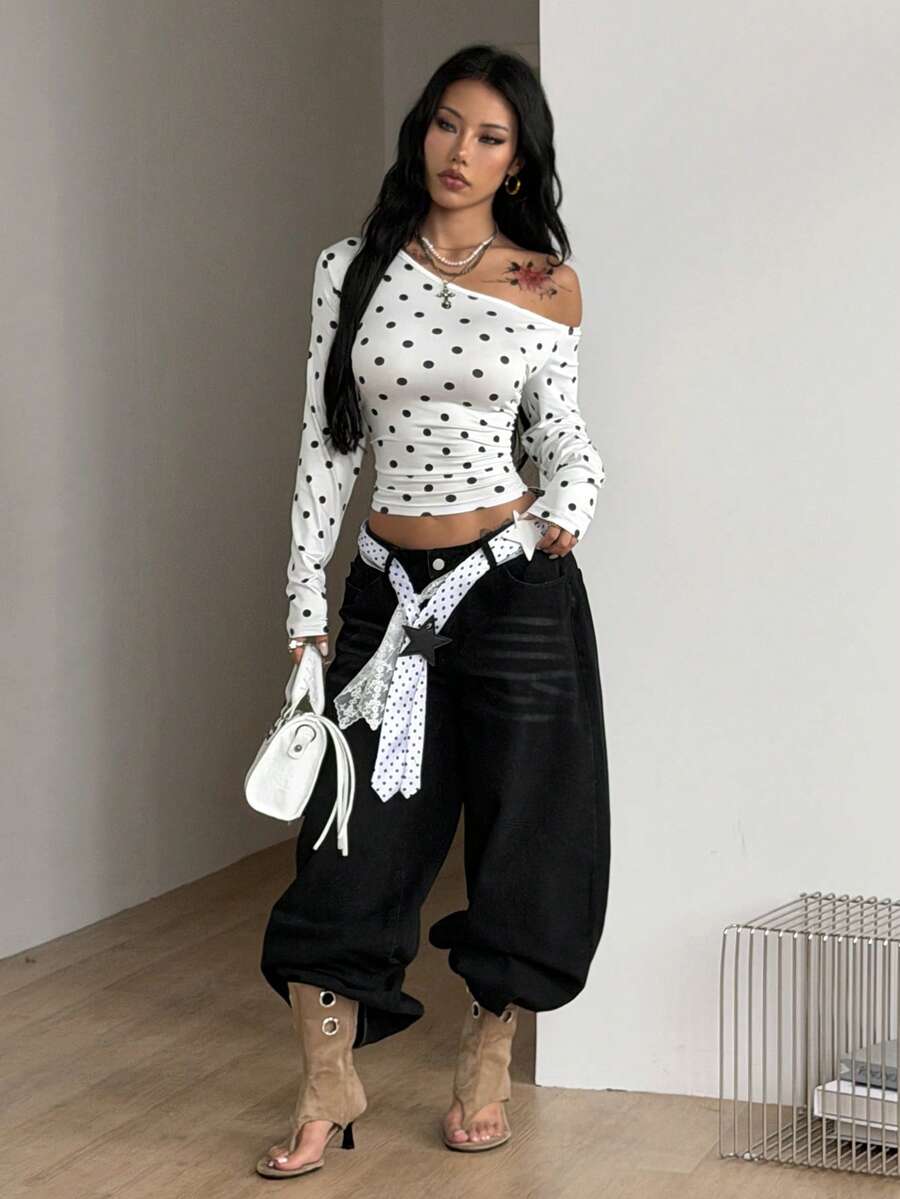 Women's slim fit long sleeve knit top featuring an asymmetrical neckline and grommet eyelet detail