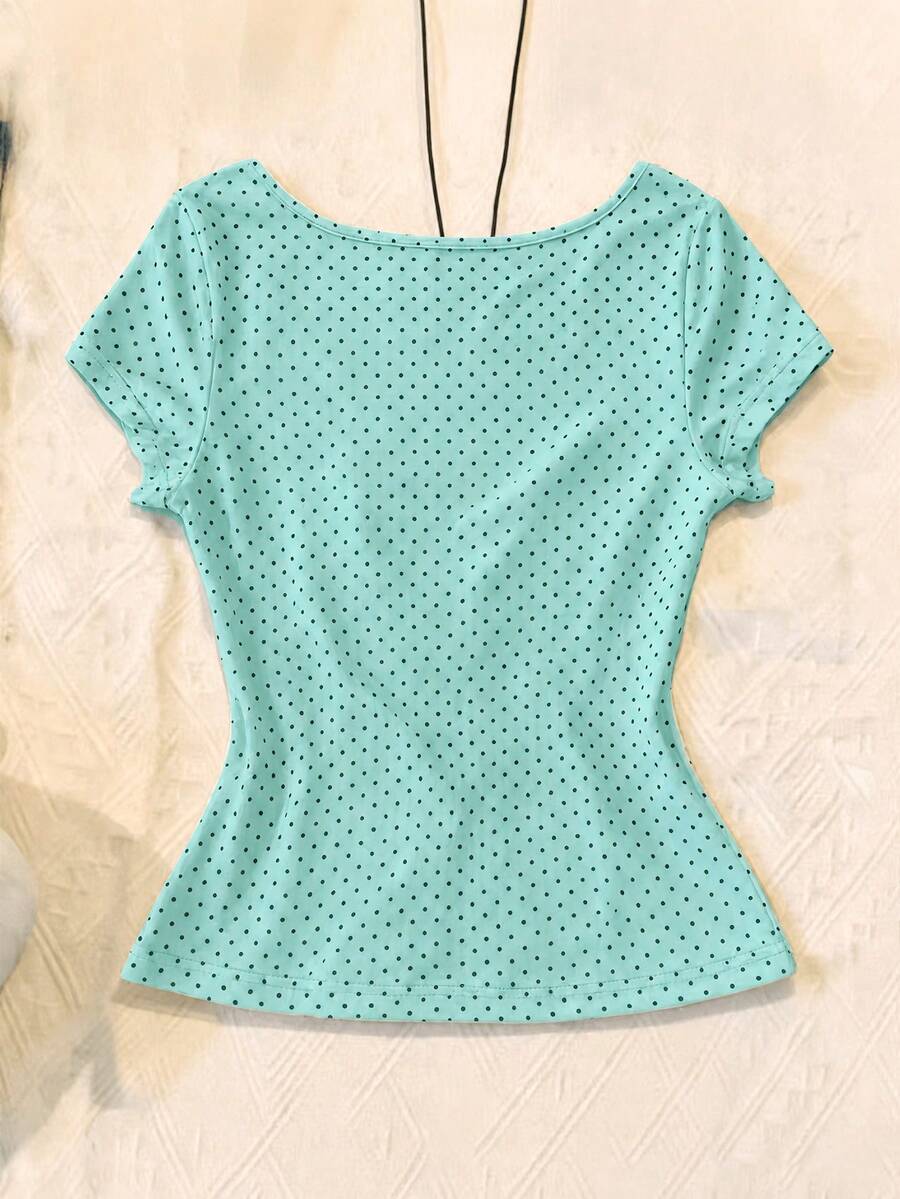 Women's polka dot short sleeve raglan t-shirt with a twist front detail and contrast collar.