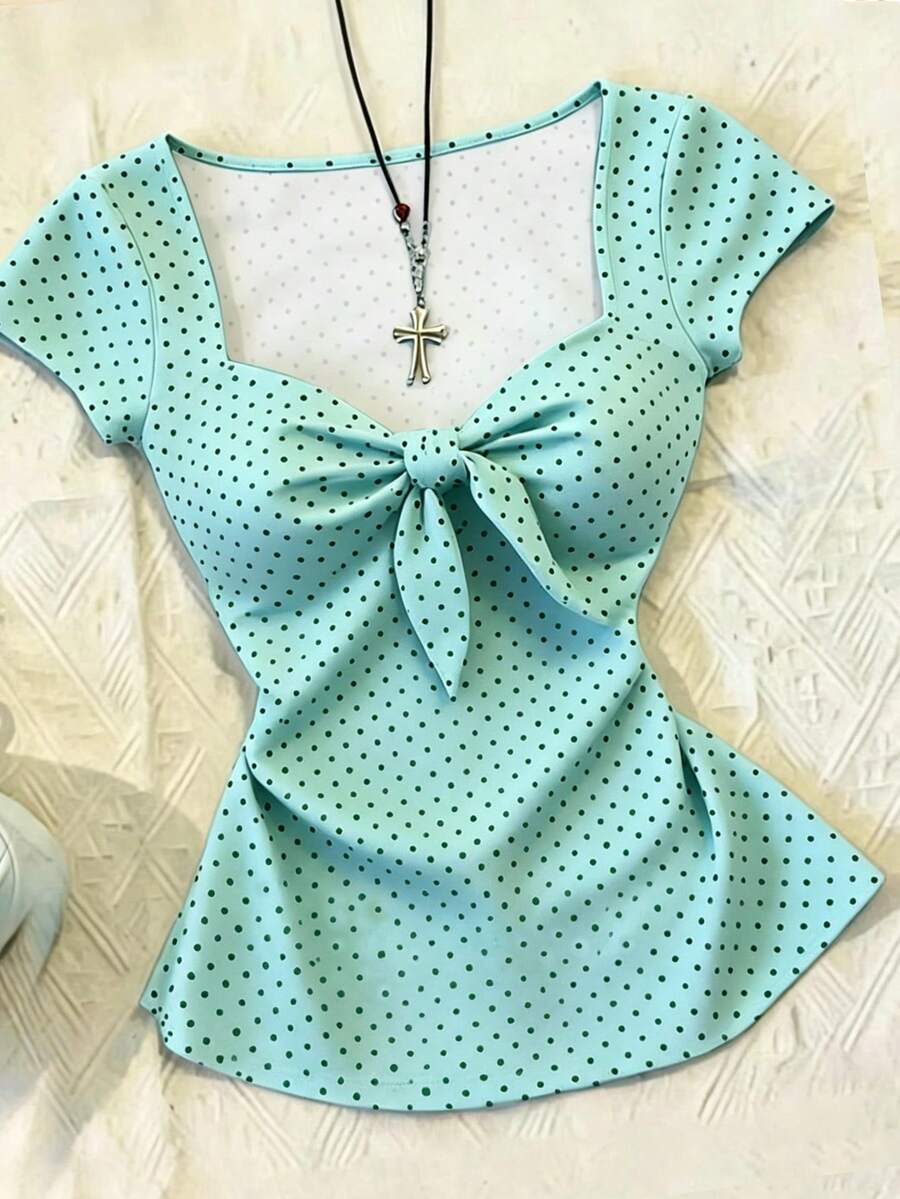 Women's polka dot short sleeve raglan t-shirt with a twist front detail and contrast collar.