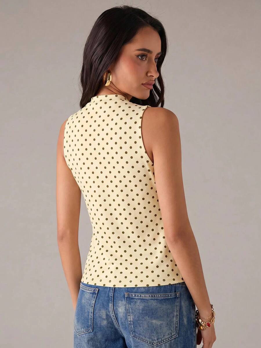 Women's sleeveless stand collar top in rib-knit fabric featuring button and hollow-out details.