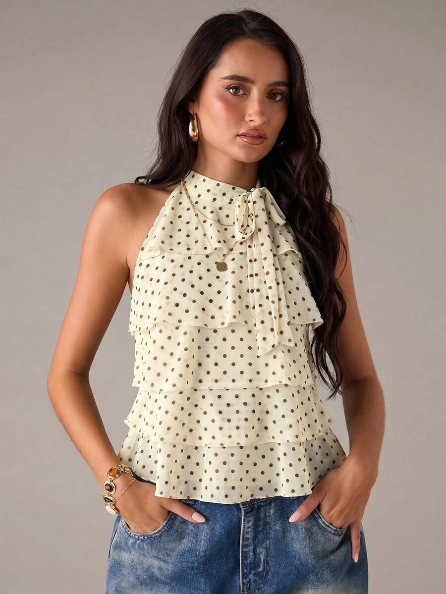 Women's sleeveless stand collar top in rib-knit fabric featuring button and hollow-out details.