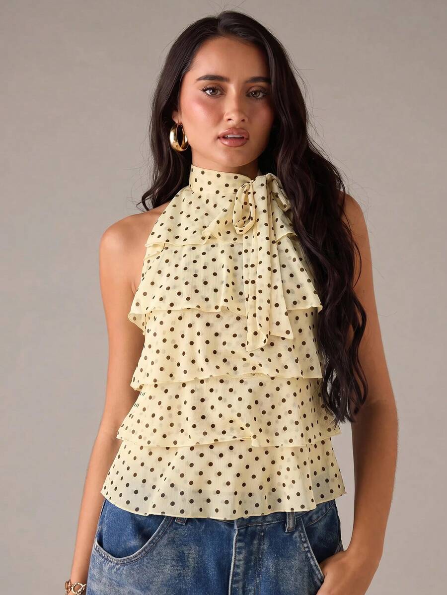 Women's sleeveless stand collar top in rib-knit fabric featuring button and hollow-out details.
