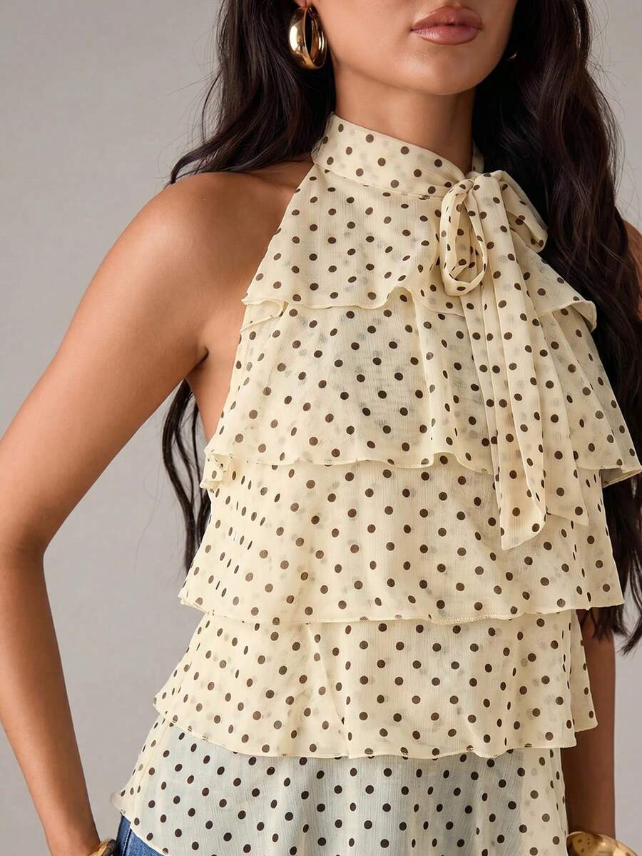 Women's sleeveless stand collar top in rib-knit fabric featuring button and hollow-out details.