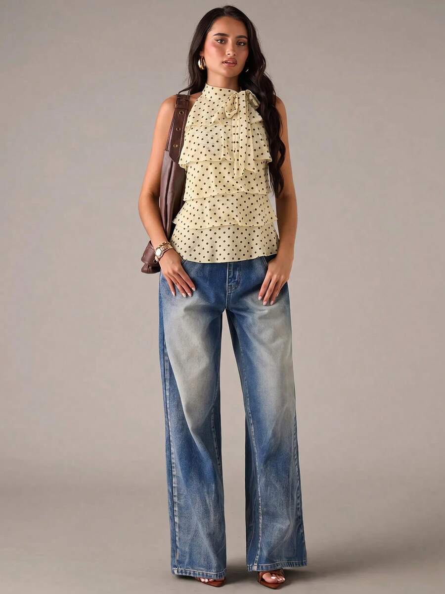 Women's sleeveless stand collar top in rib-knit fabric featuring button and hollow-out details.