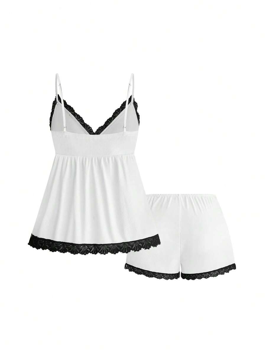Two-piece ribbed pajama set featuring a lace-trimmed crop camisole top with spaghetti straps and matching shorts.